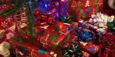 Assorted wrapped Christmas gifts near decorated tree